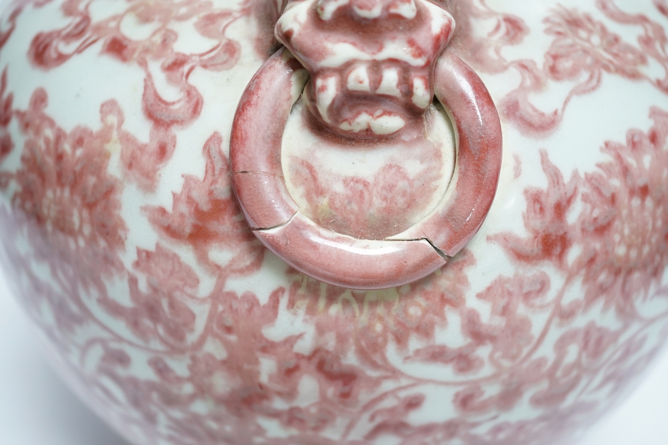 A Chinese underglaze copper red floral vase with twin handles, 27cm high
